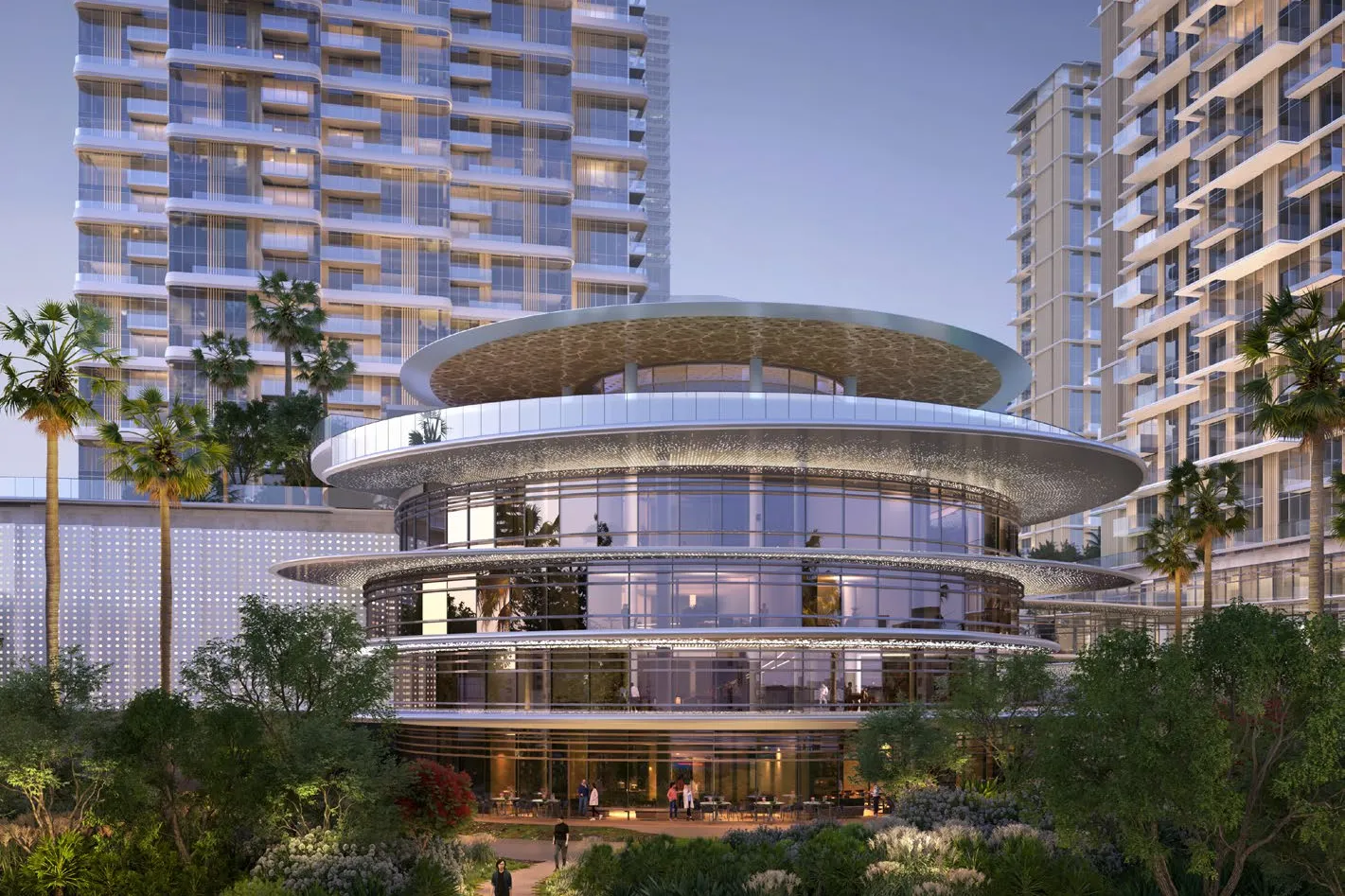 Circular glass clubhouse among gardens with towers behind at dusk