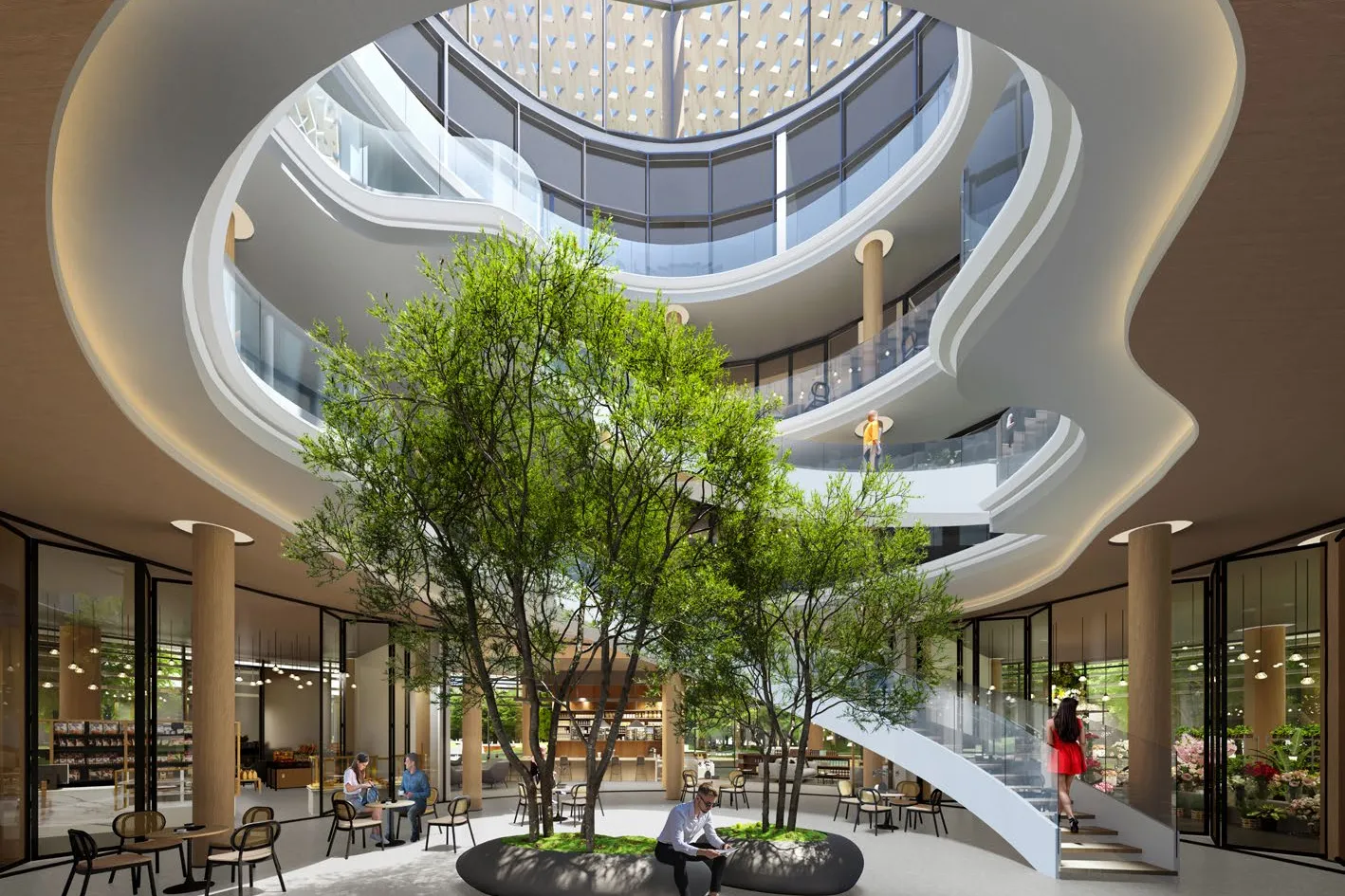 Clubhouse atrium with trees, café tables and a curving staircase